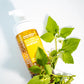 Neogen Real Fresh Heartleaf Cleansing foam with green leaves on a light background
